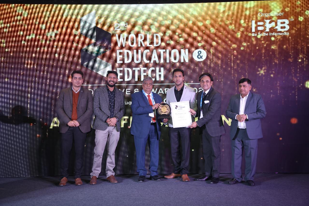 New Public College leadership receiving a trophy at the World Education and EdTech Awards