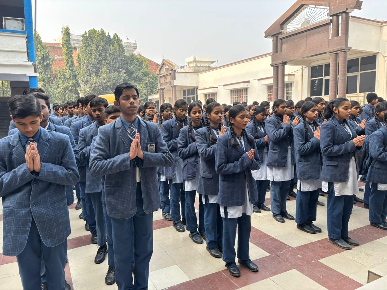 Students of New Public College standing in morning assembly in the school courtyard